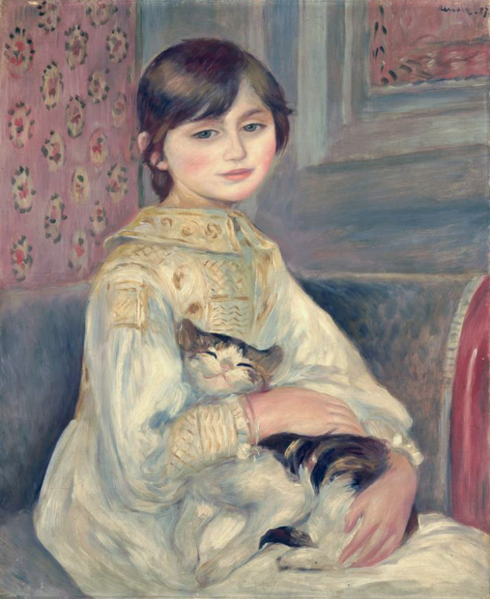 Mädchen im weißen Kleid hält eine Katze auf dem Schoß.